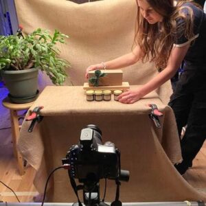 Person setting up for product photography